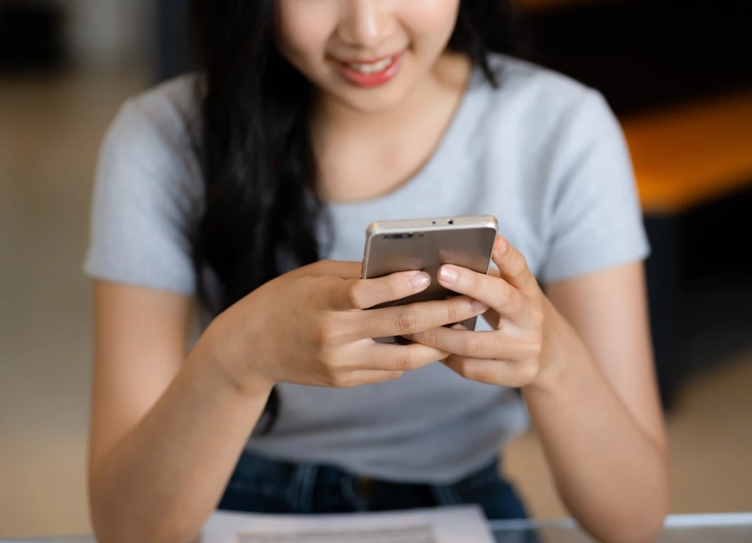 Girl holding phone searching for Treasury Management App